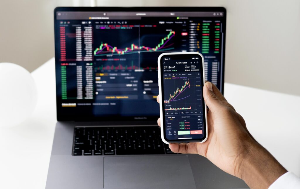 The investor looking at stock market charts on his laptop and mobile – Best Small Cap ETF in India 2025
